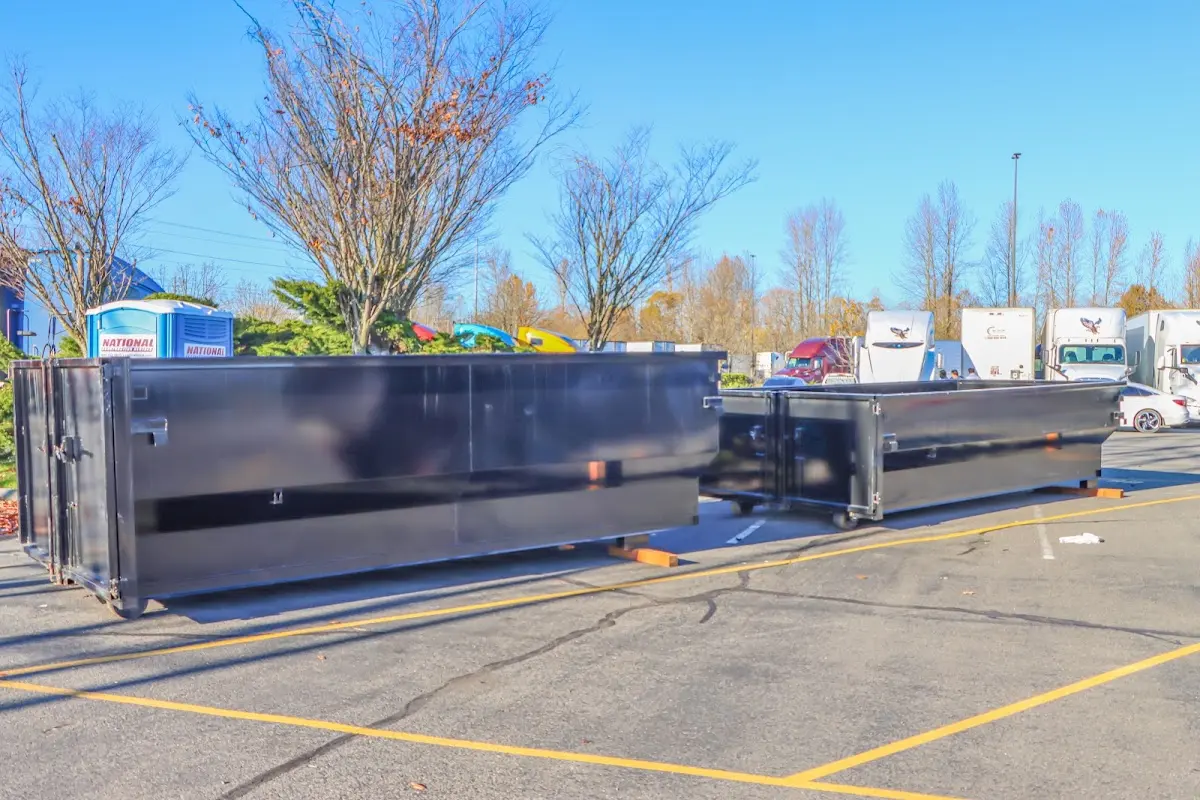 Professional dumpster rental service with roll-off container on residential driveway in Oakwood